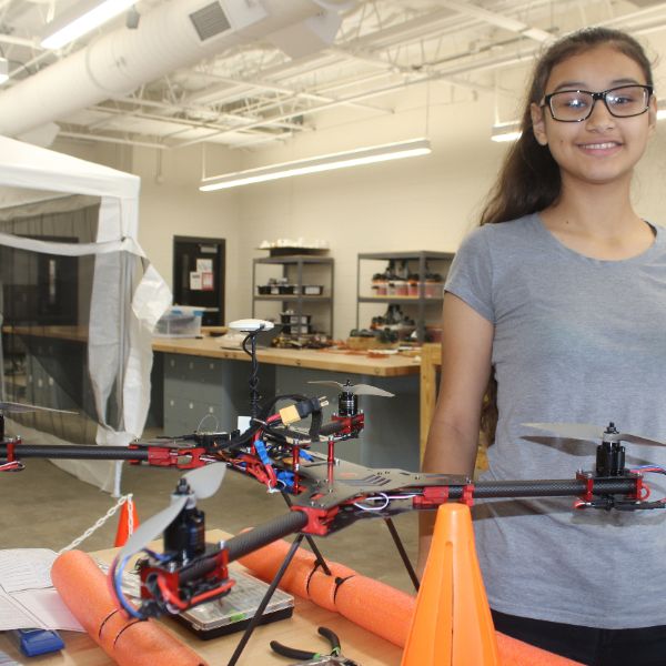  Photo of student next to a drone